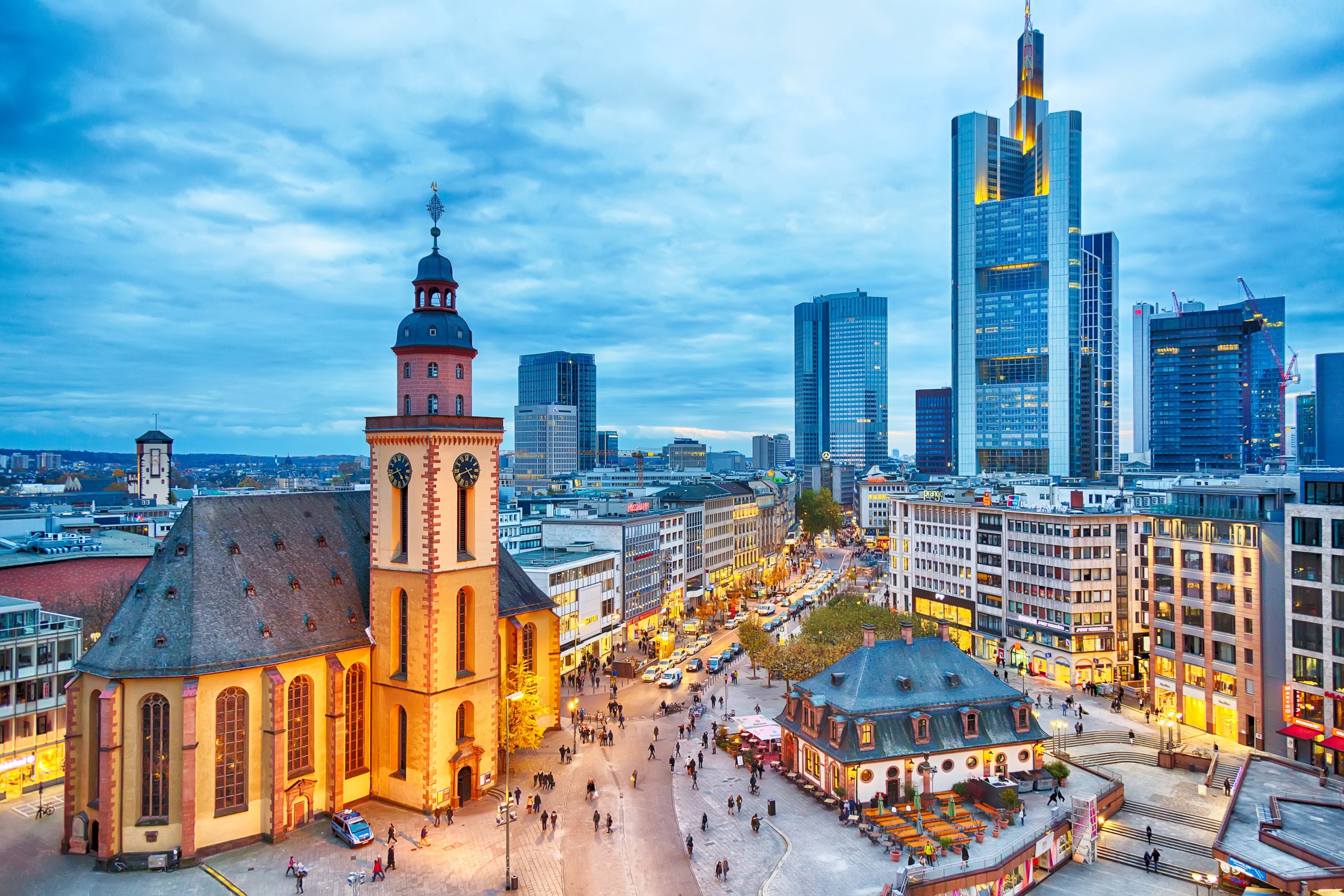 FRANKFURT, GERMANY - NOVEMBER, 2017: View to skyline of Frankfurt in sunset blue hour. St Paul's Church and the Hauptwache Main Guard building at Frankfurt central street Zeil